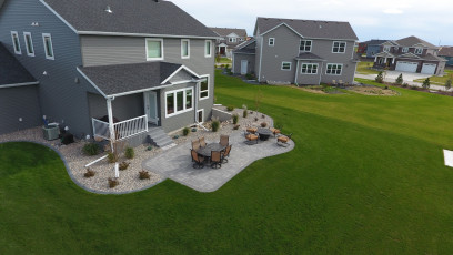 grey patio with grey house in west Fargo by oasis landscapes