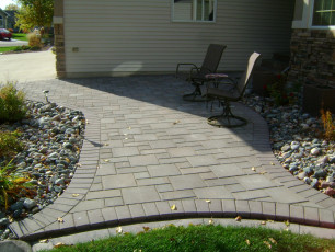 small earth tone paver patio by oasis landscapes