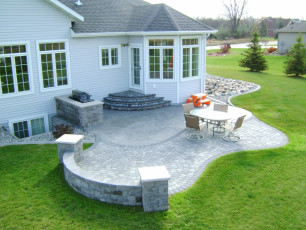 Fargo home with backyard patio by oasis landscapes