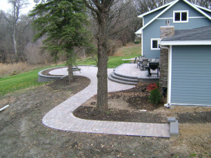 West Fargo home with sidewalk landscaping by oasis landscapes