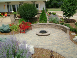hardscape patio with red bench in west fargo by oasis landscapes