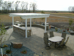 white pergola covering outdoor kitchen by oasis landscapes