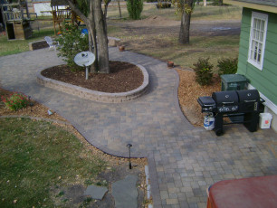retaining wall hardscape around tree in Fargo by oasis landscapes