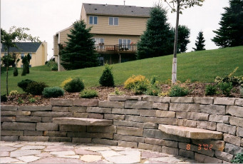 retaining wall with sitting stones in Fargo by Oasis Landscapes