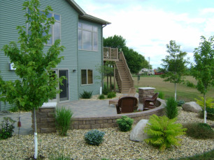 Blue house with landscaping installed by Oasis Landscapes
