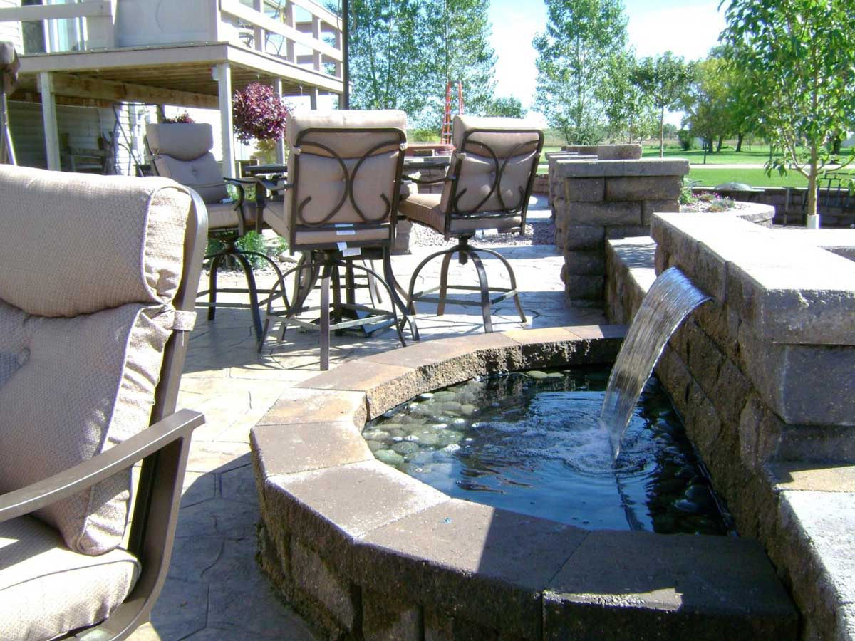 Hardscape Patio with water feature. Landscape design by Oasis Landscapes