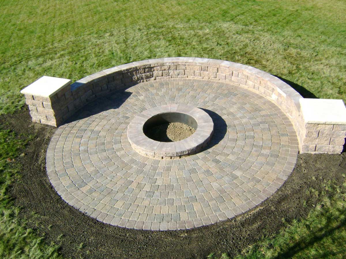 Circle patio with fire pit in West Fargo by Oasis Landscapes