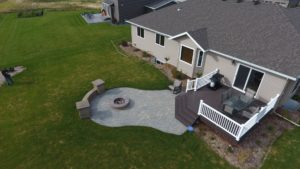 Deck with stairs, patio, seat wall, and fire pit in West Fargo, ND