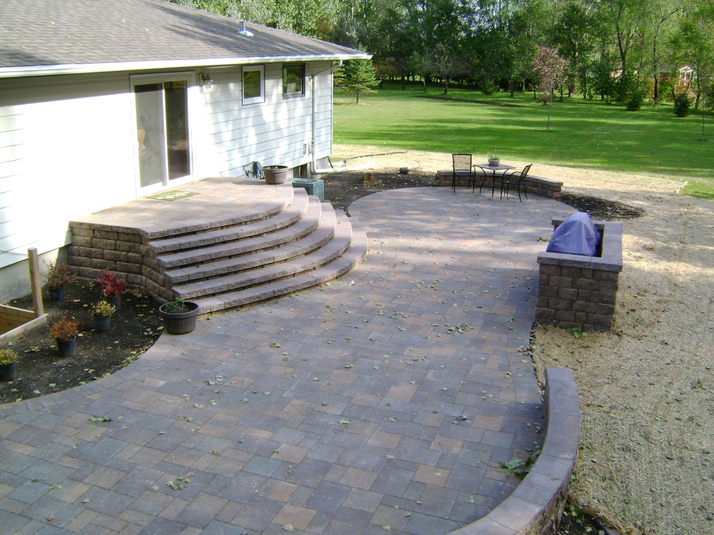 Paver patio with staircase and grilling station