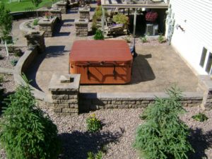Patio with Hot Tub, Retaining Walls, and Raised Plant Beds in West Fargo, ND