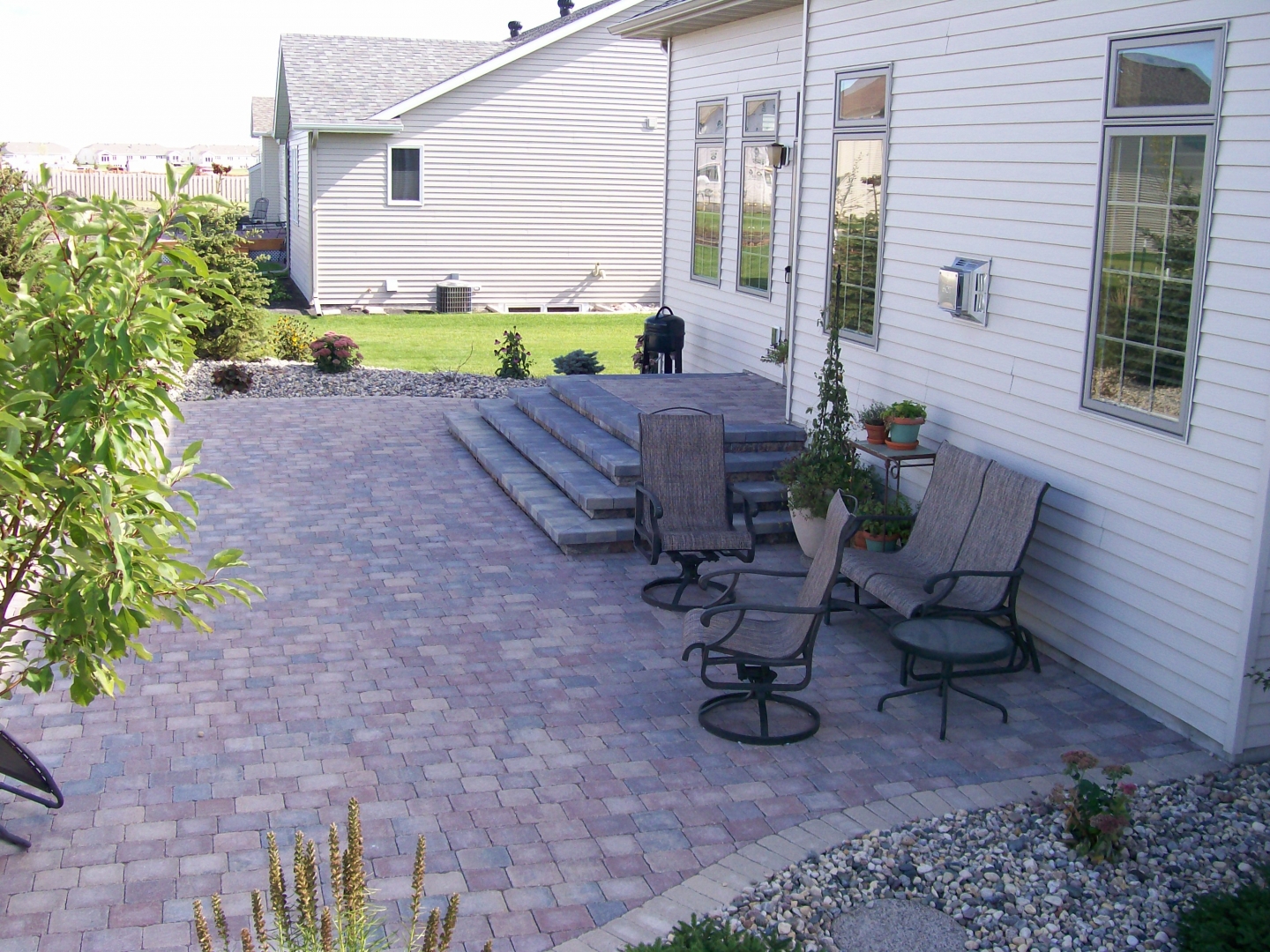 Multi-Colored Paver Patio with Stair System and Rock Fill Edging