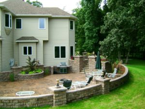Stained Concrete Patio, Retaining Walls, Staircase, and more installed by Oasis Landscapes in West Fargo ND