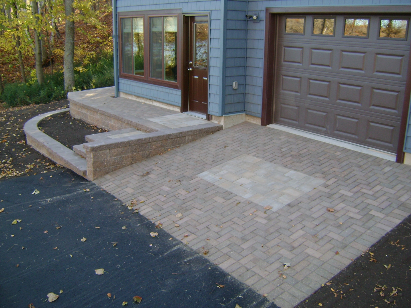 Paver Driveway, Retaining Walls, and Stairs, by Oasis Landscapes in West Fargo