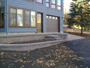 Side View of Paver Driveway, Retaining Walls, and Stairs, by Oasis Landscapes in West Fargo