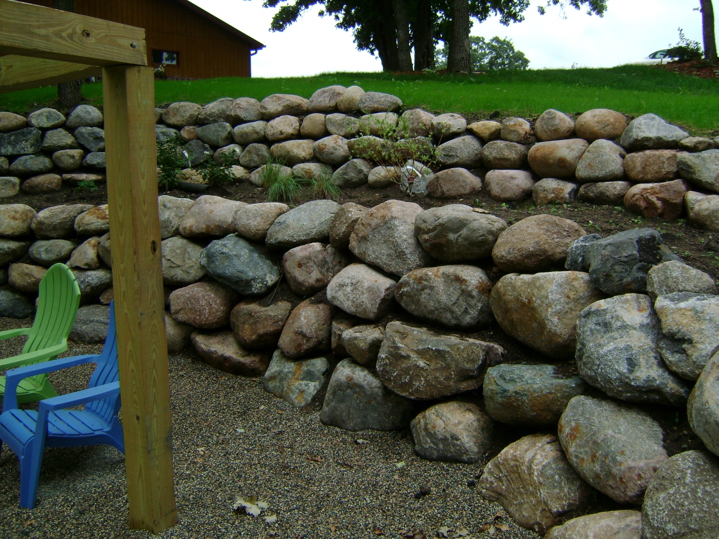 Boulder Retaining Wall With Patio And Paver Stair Case Oasis Landscapes