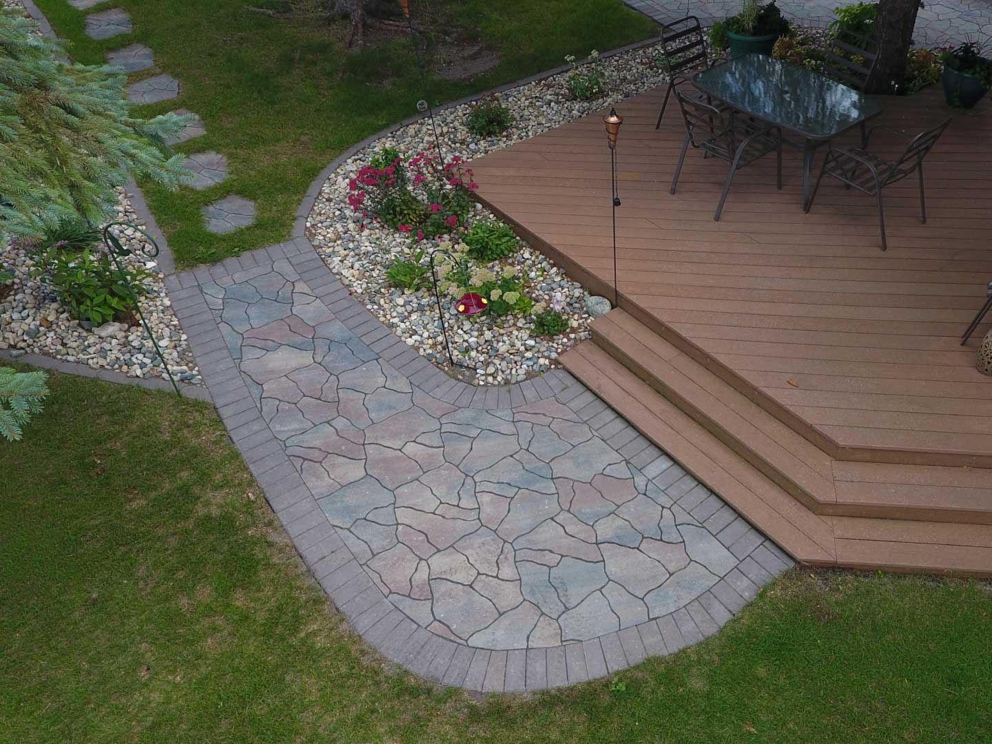 Deck with paver walkway, lanscape edgin, and rock fill