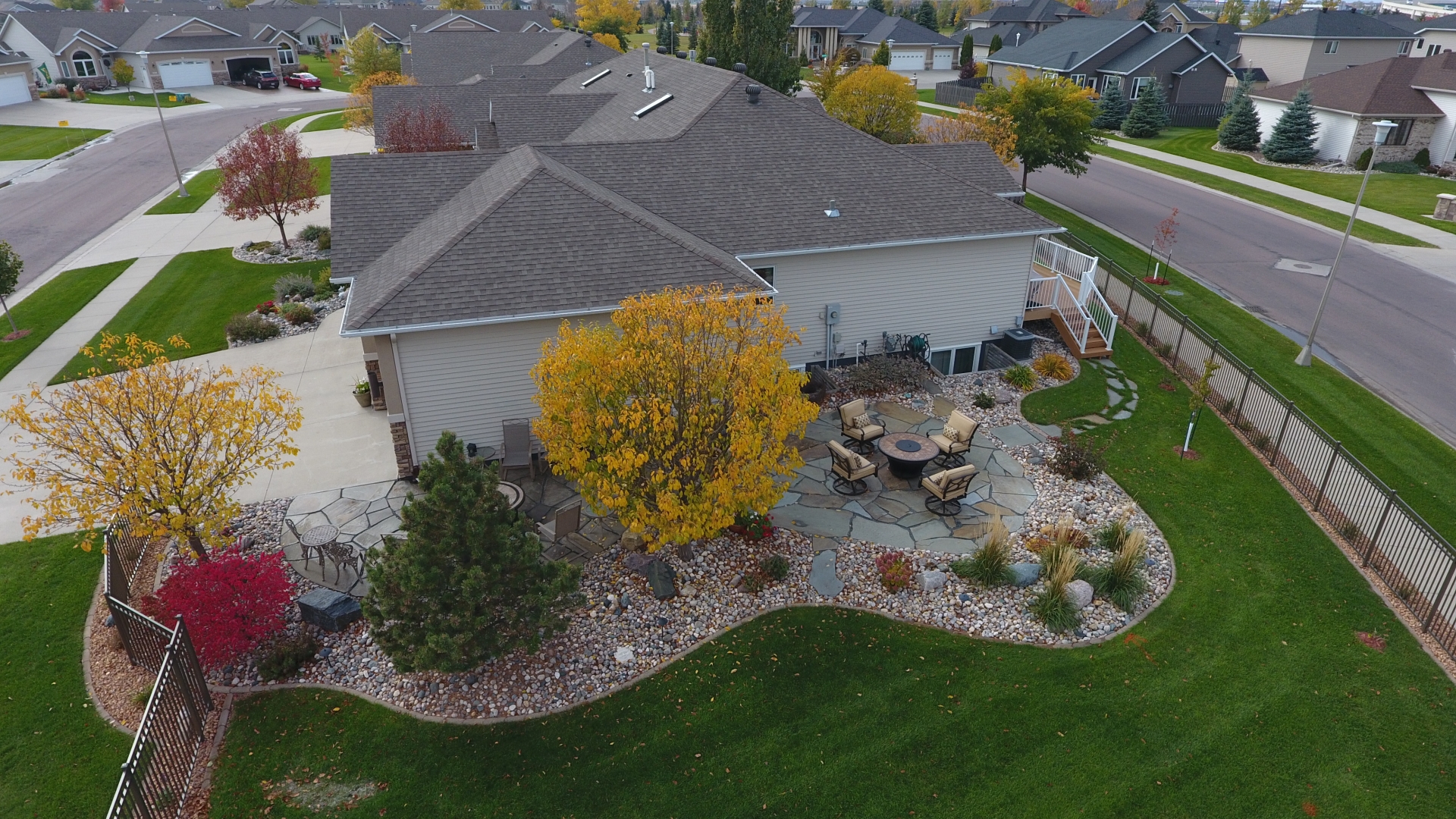 landscaping in west Fargo with large stone patio and colorful trees