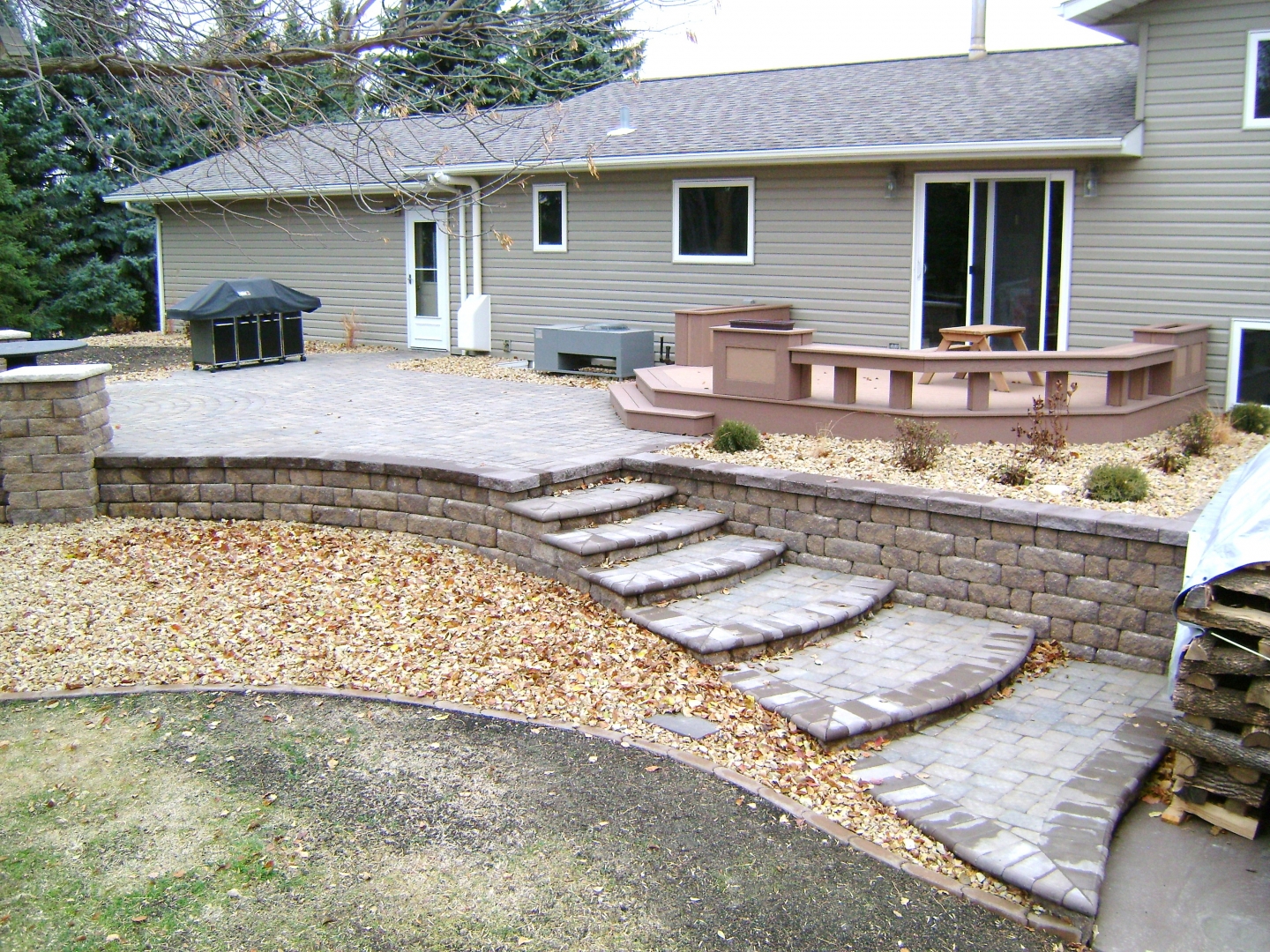 Raised Paver Patio with Retaining Walls, Stairs, Deck, and Seating Wall