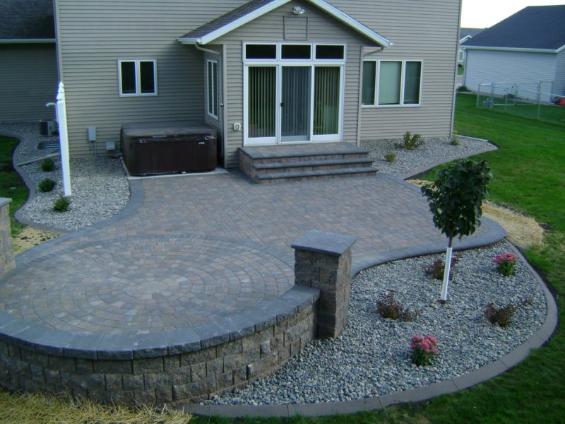 Earth Tone Paver Patio with Sitting Wall and Rock Fill Edging - Oasis ...